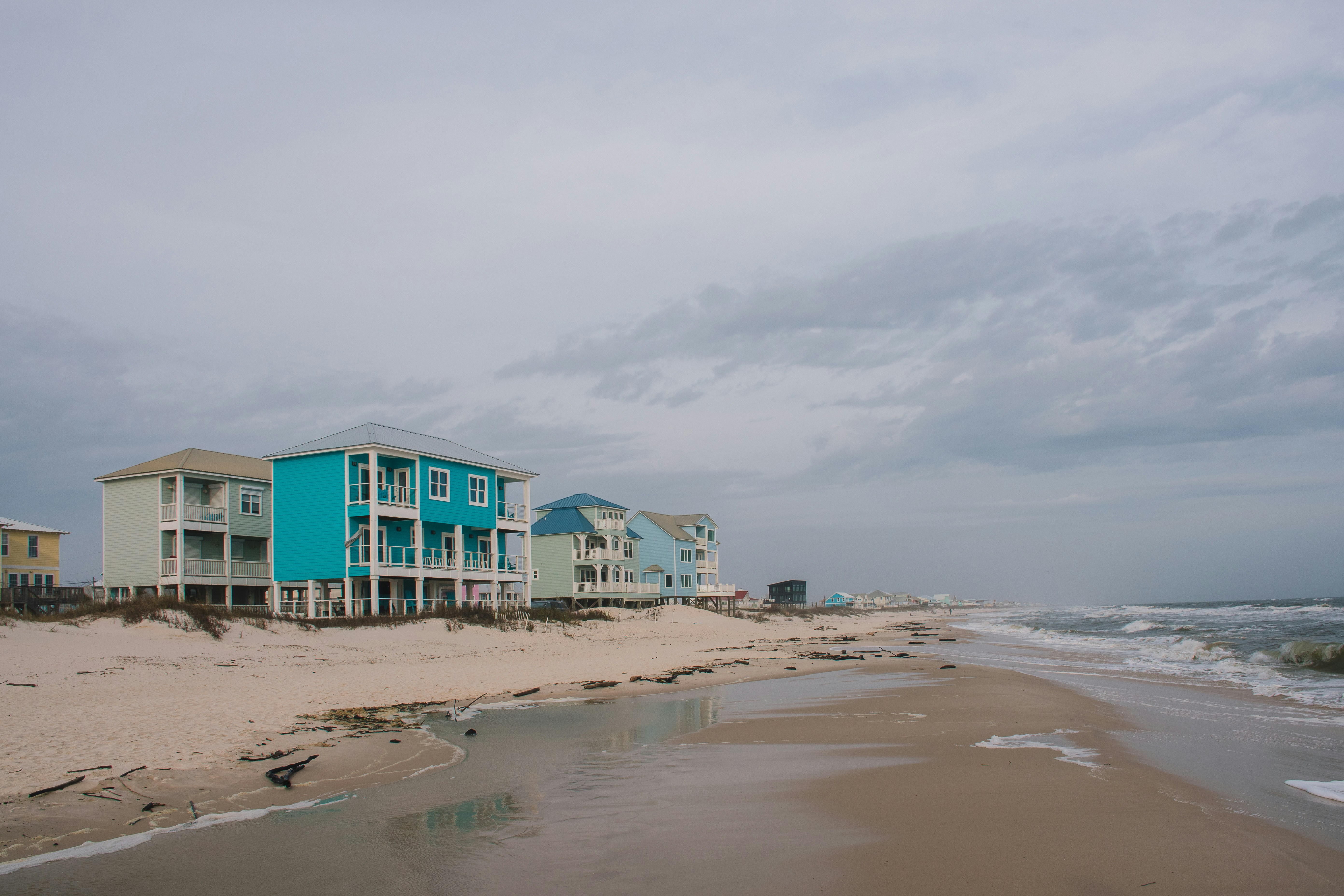 a row of beach houses on a cloudy day, Beach houses along the Gulf of Mexico in the off-season