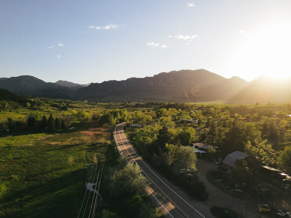 an aerial view of a rural area with mountains in the background