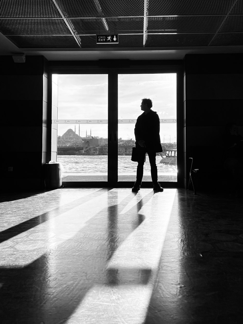 a man standing in front of a large window