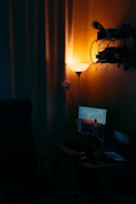 A cozy streaming corner with soft tan walls, a gaming PC glowing softly, and no people visible