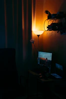 A cozy home office setup with warm lighting and a laptop ready for an online therapy session.