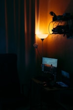 A cozy home office with a glowing yellow Upnet router casting warm light against a dark background.