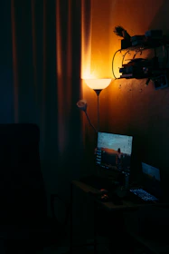 A cozy home office corner bathed in soft violet light from a smart lamp, reflecting smooth lines and elegant minimalism.