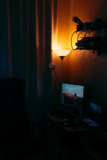 A warm and inviting home office with soft lighting, a cozy chair, and a laptop ready for an online therapy session.