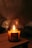 A warmly lit candle labeled 'Tonka + Macadamia' with the words 'Hand Poured Soy Candle' is placed on a wooden surface, emitting a gentle flame. The background is softly blurred, creating a cozy and serene ambiance.