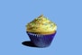 a cupcake with yellow frosting and sprinkles