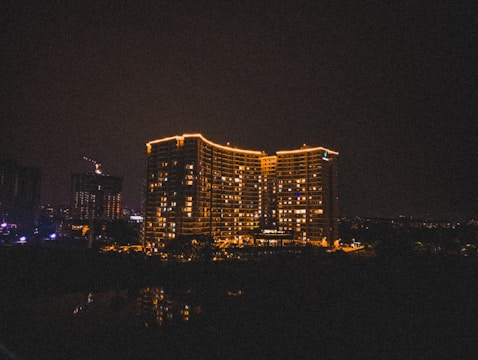 Night view of a completed building illuminated with warm lights.
