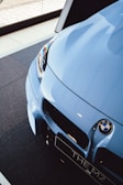 a close up of the front of a blue sports car