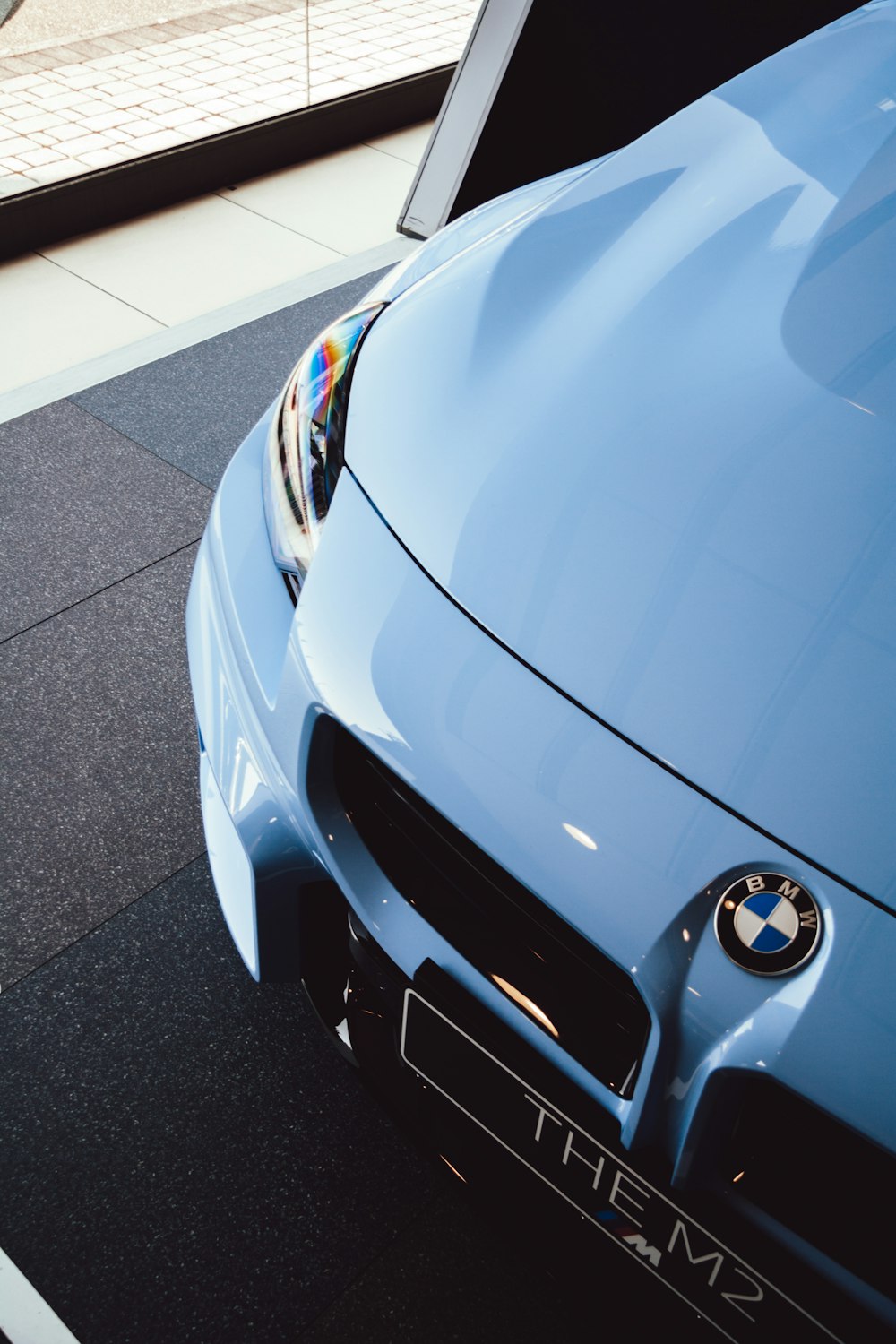 a close up of the front of a blue sports car