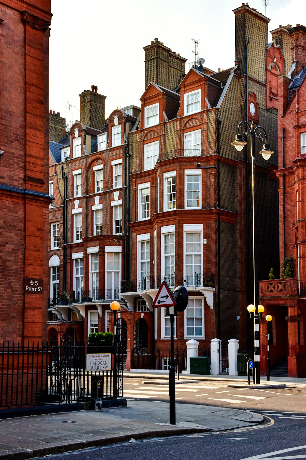 a row of red brick buildings on a city street