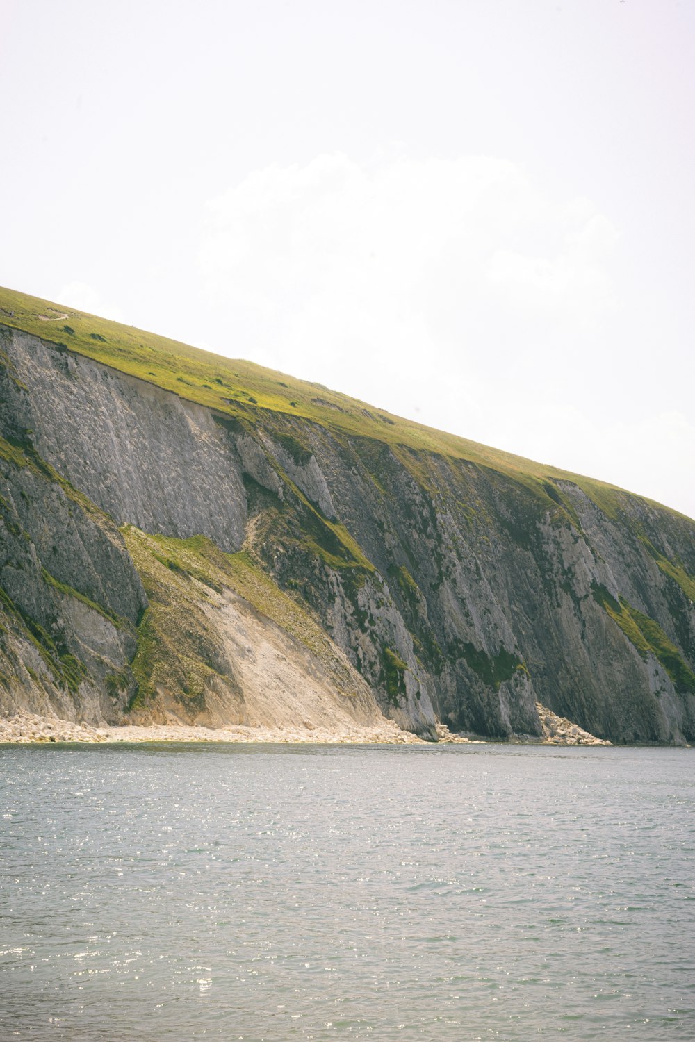 a large body of water with a mountain in the background