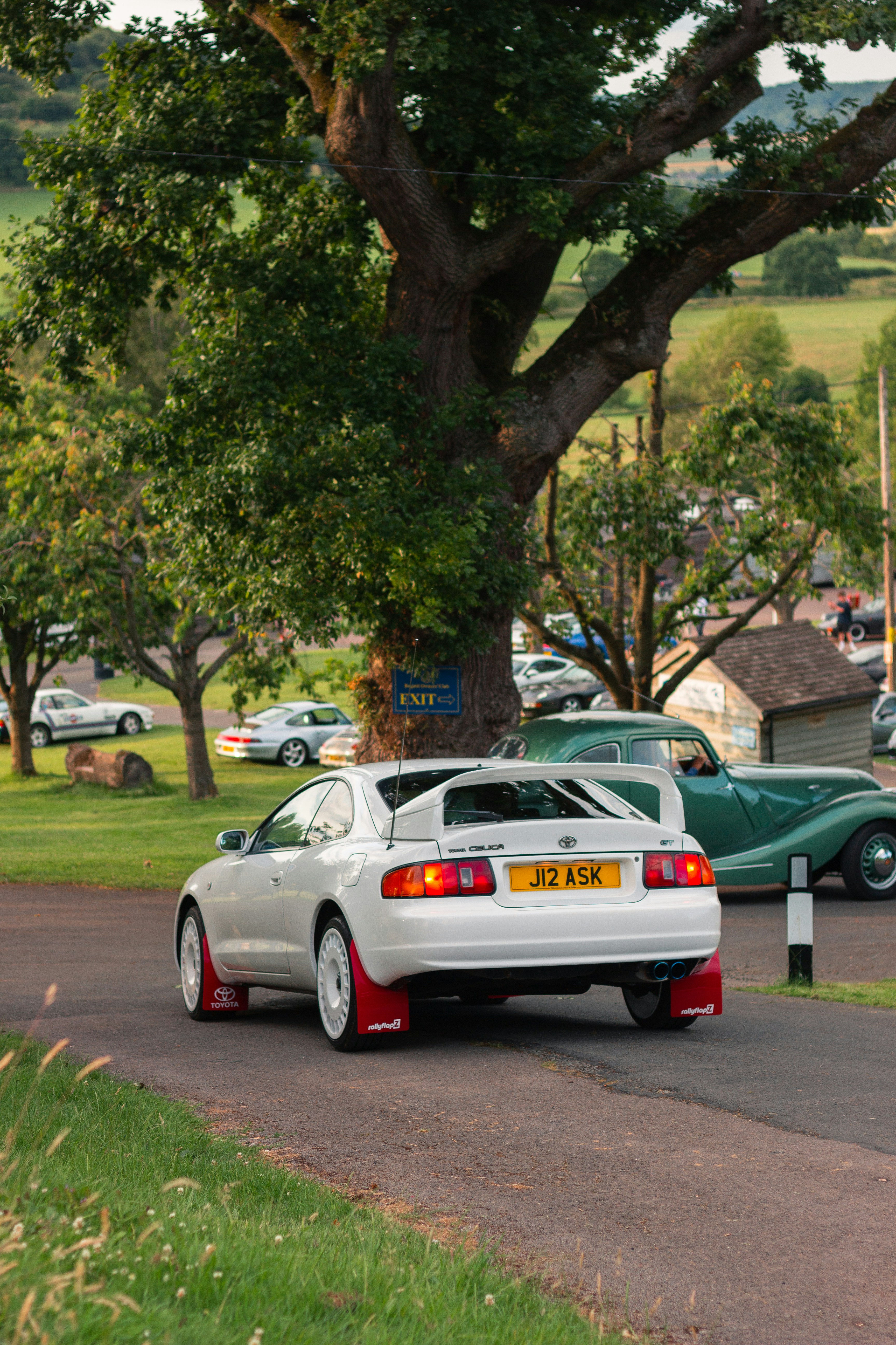 a white car parked on the side of a road