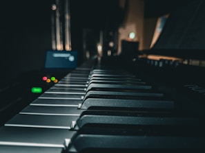 a close up of a piano keyboard in a dark room