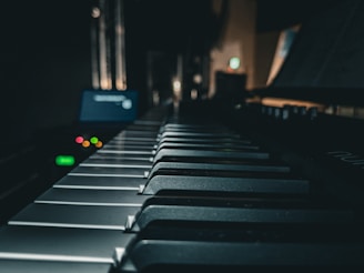 a close up of a piano keyboard in a dark room