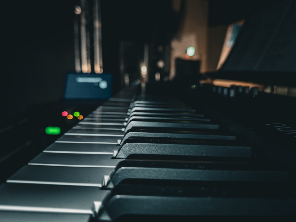 a close up of a piano keyboard in a dark room