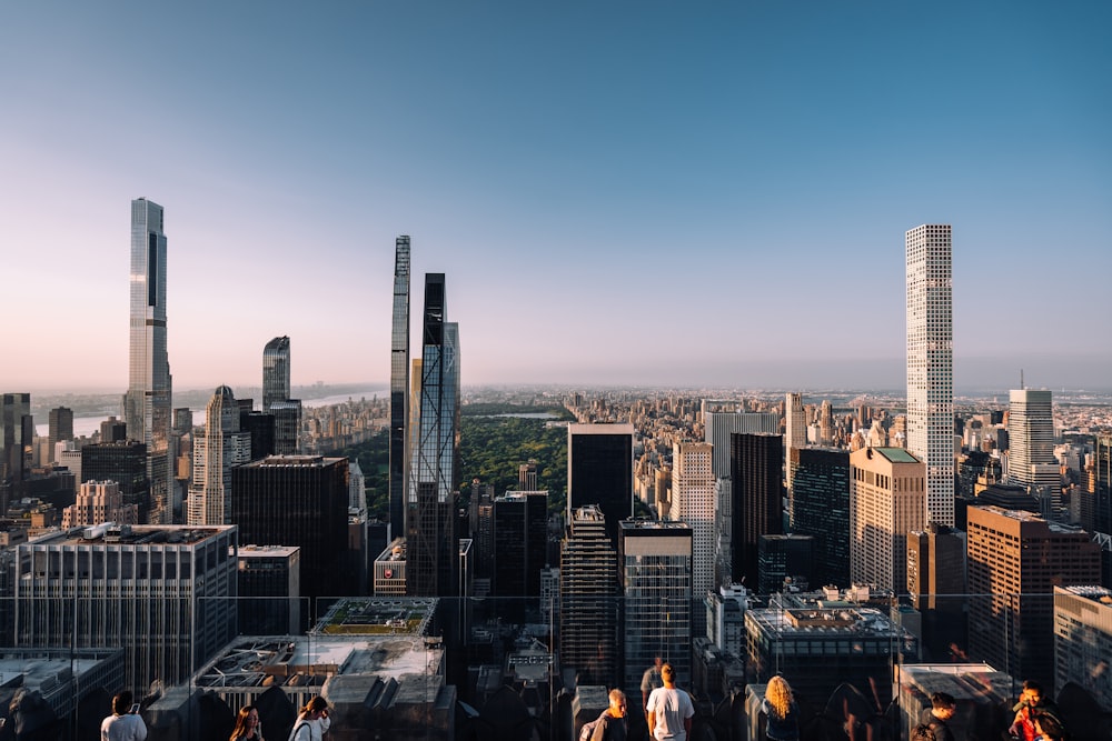 a group of people standing on top of a tall building