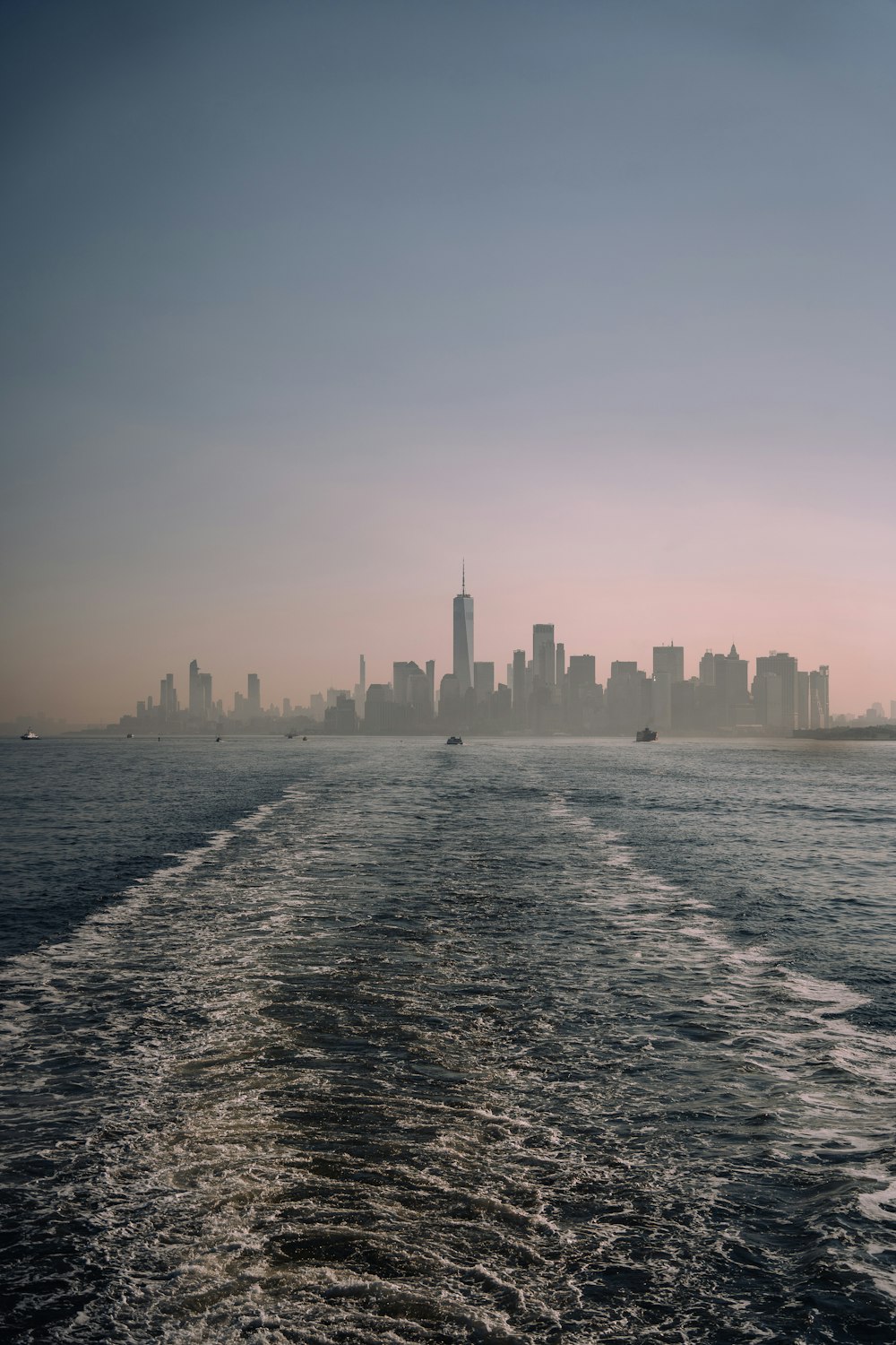 the skyline of a large city as seen from a boat