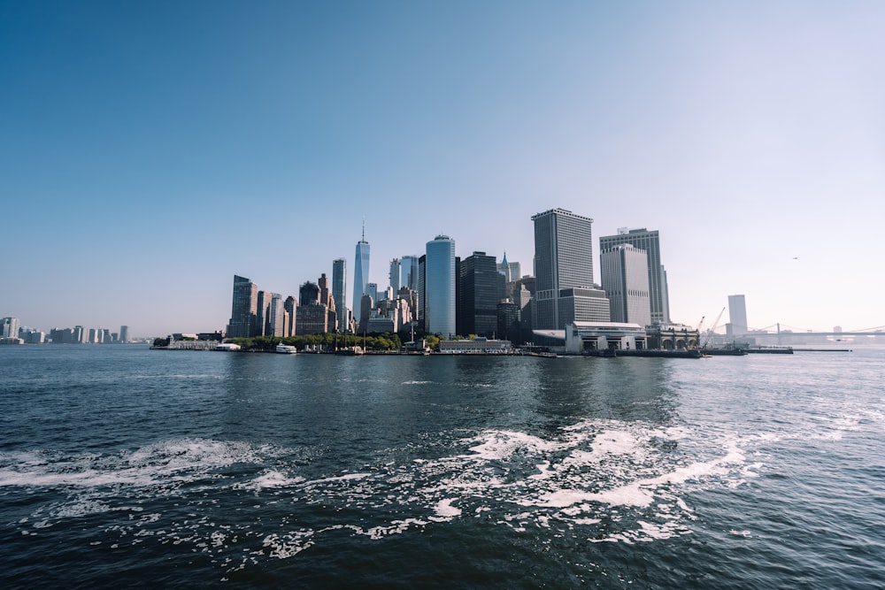 a large body of water with a city in the background