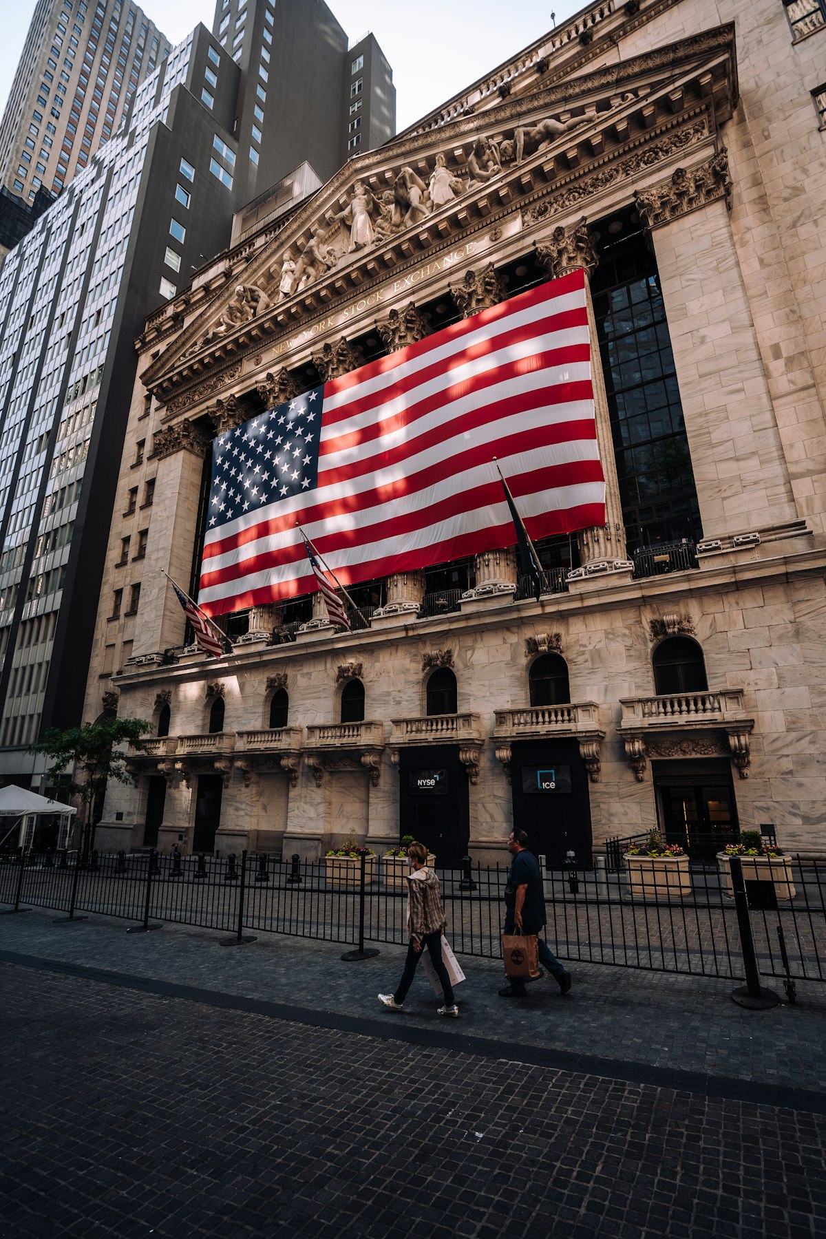 New York Stock Exchange building with American flag on Wall Street