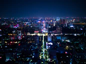 Urban Quito skyline at night with neon lights reflecting the city’s energy.