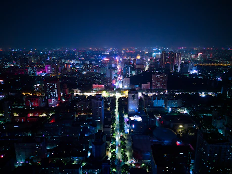 Vibrant city nightlife with neon lights and people enjoying an evening out.