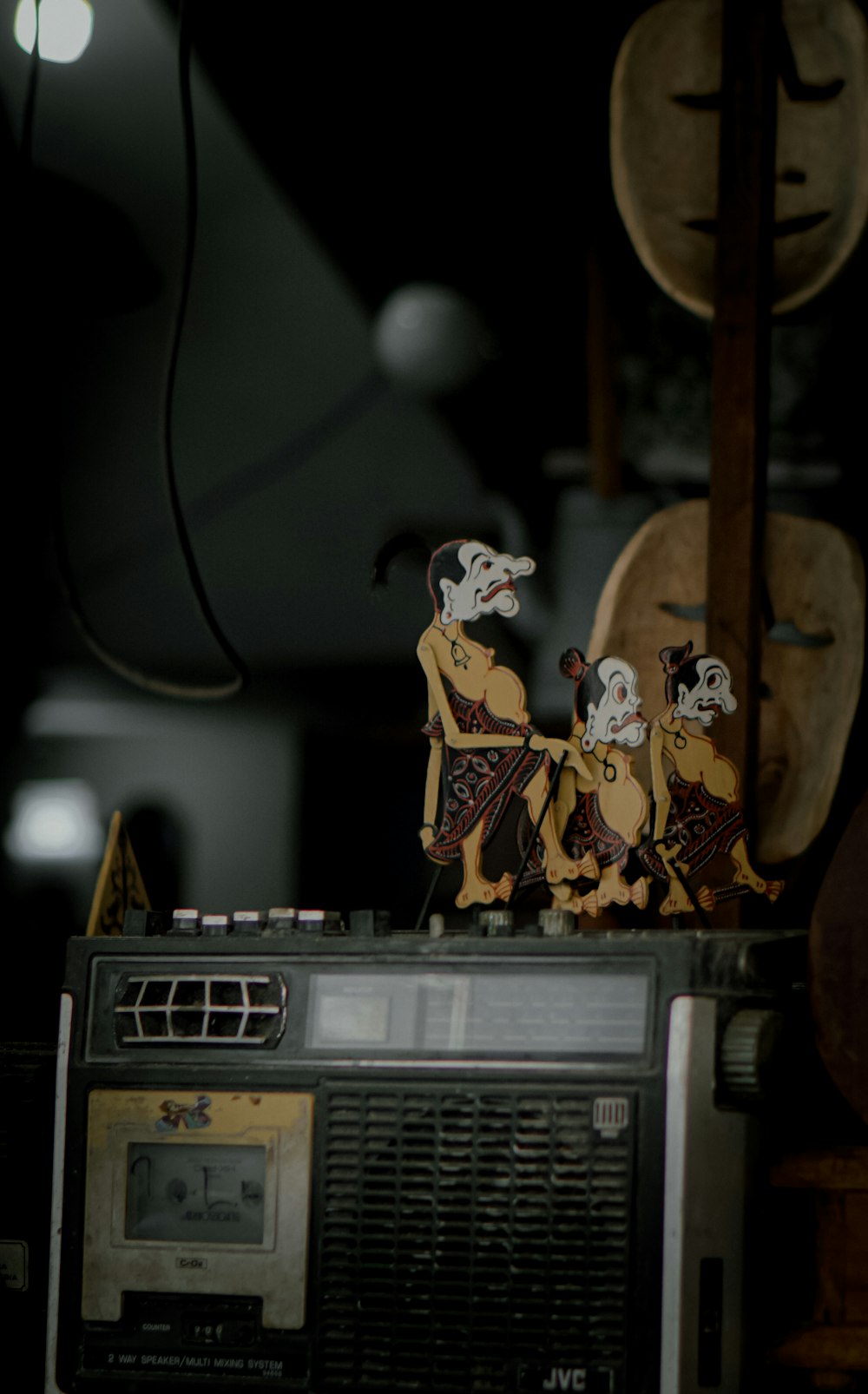 a couple of figurines sitting on top of a radio