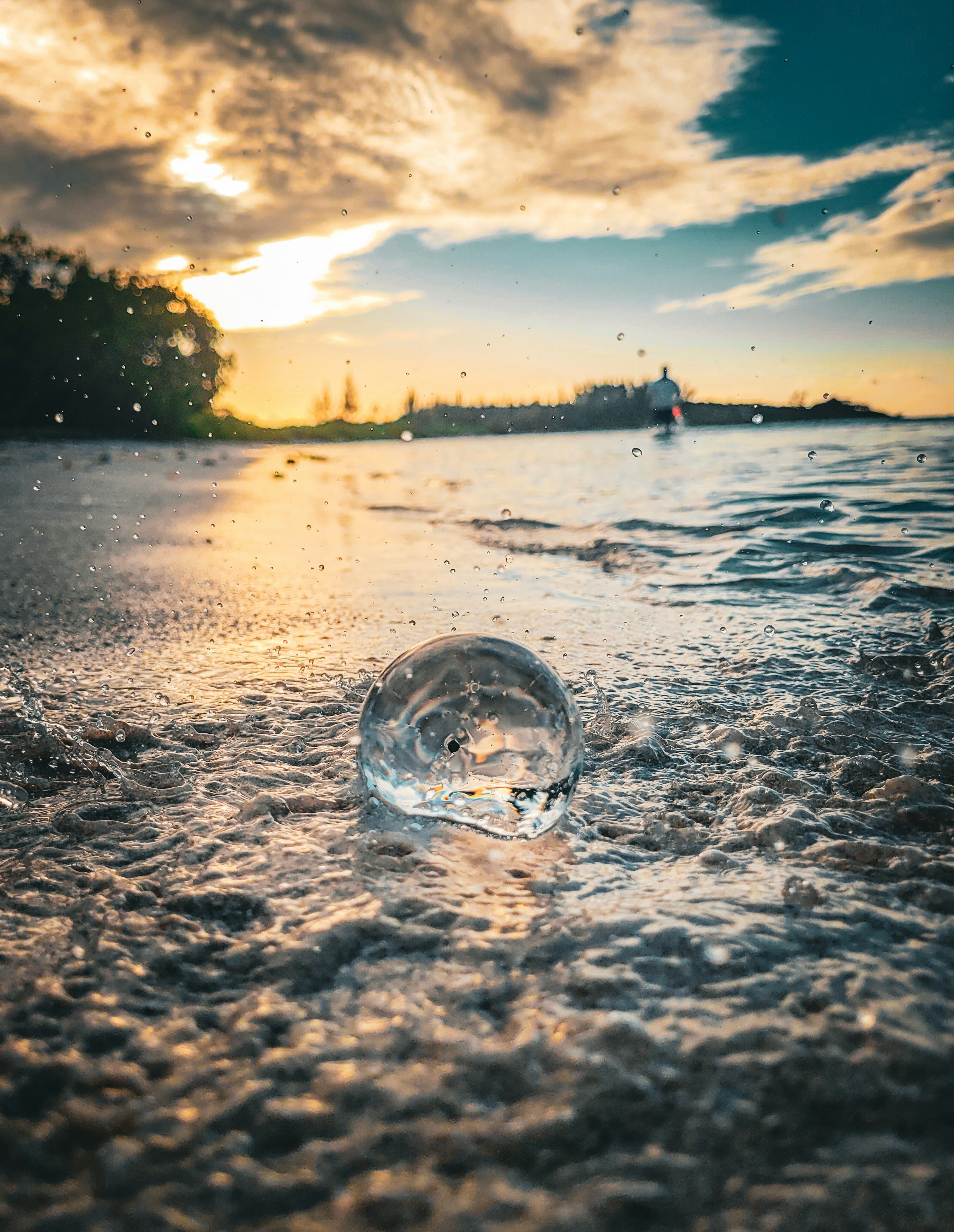 a glass ball floating on top of a body of water