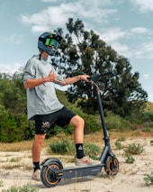 a man riding a scooter on a dirt road