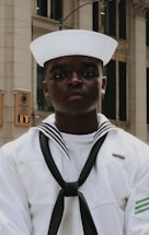 A friendly customer service representative assisting a sailor over the phone.