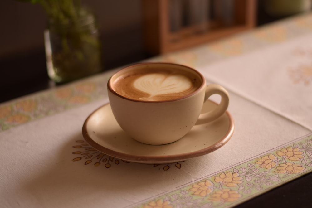 a cup of coffee on a saucer on a table