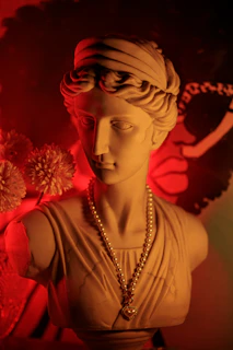 Elegant lace choker displayed on a stone bust against a backdrop of the Arno river at sunset.