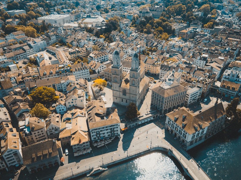 an aerial view of a city next to a body of water