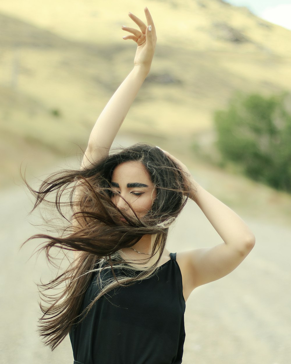 a woman with her hair in the air