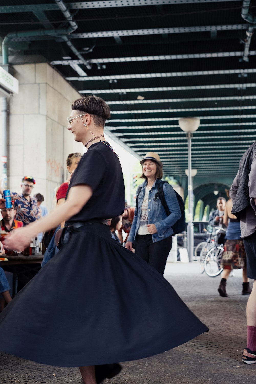 a woman in a black dress is dancing