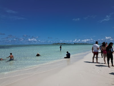Happy travelers enjoying a sunny Mexican beach with clear blue water.