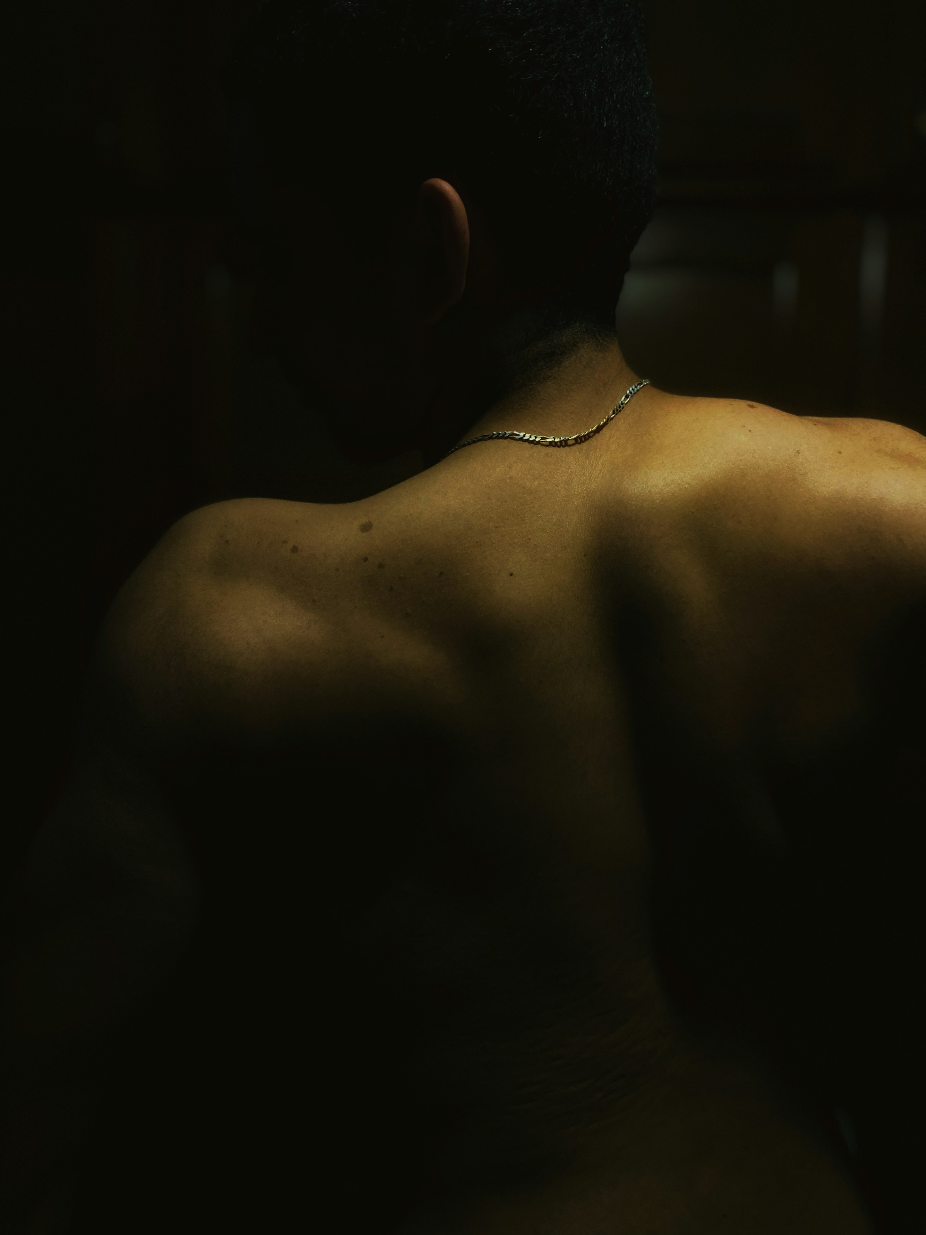 a man with a chain around his neck