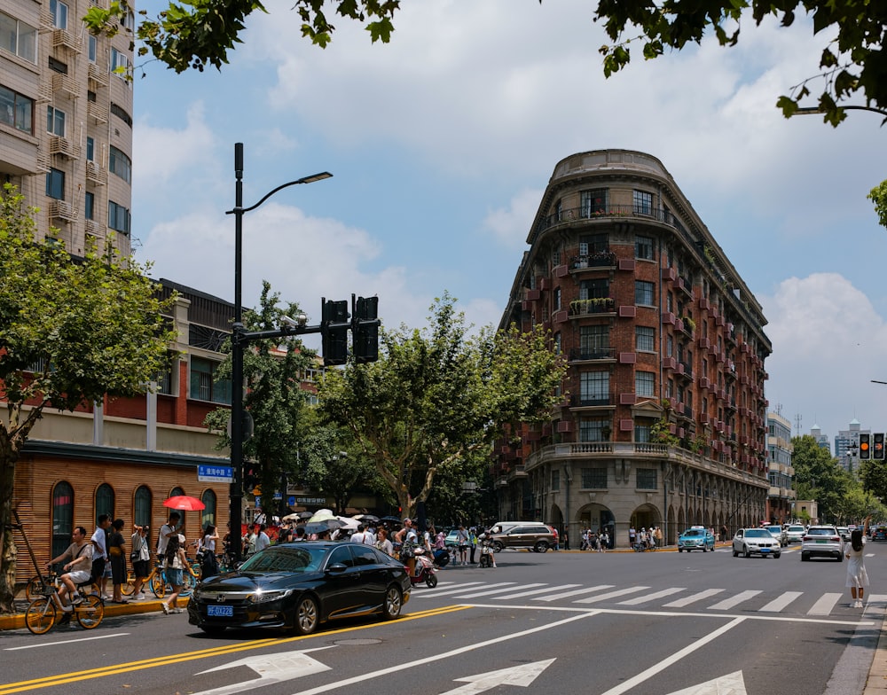 a busy city street with a tall building in the background