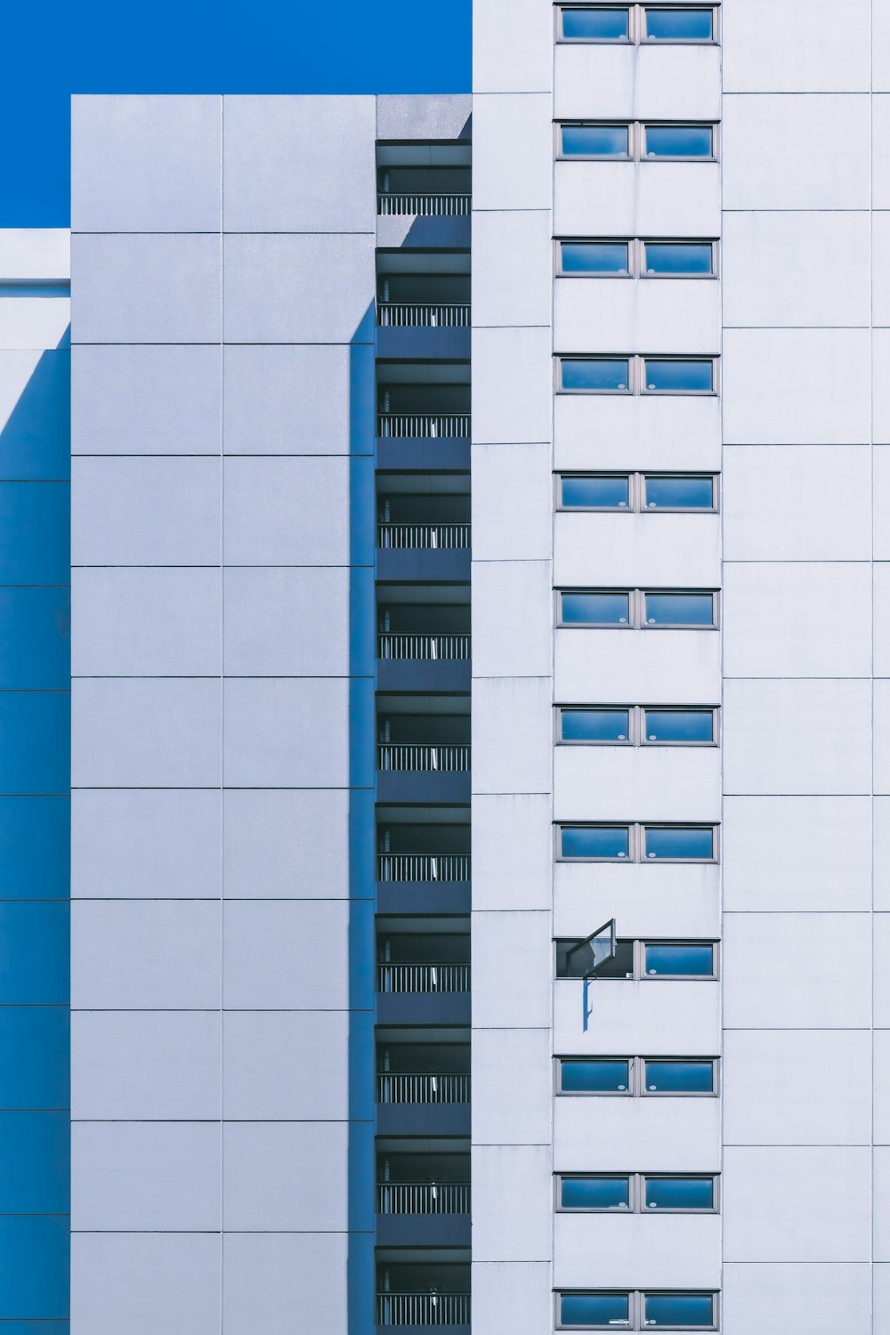 a tall white building next to a tall white building