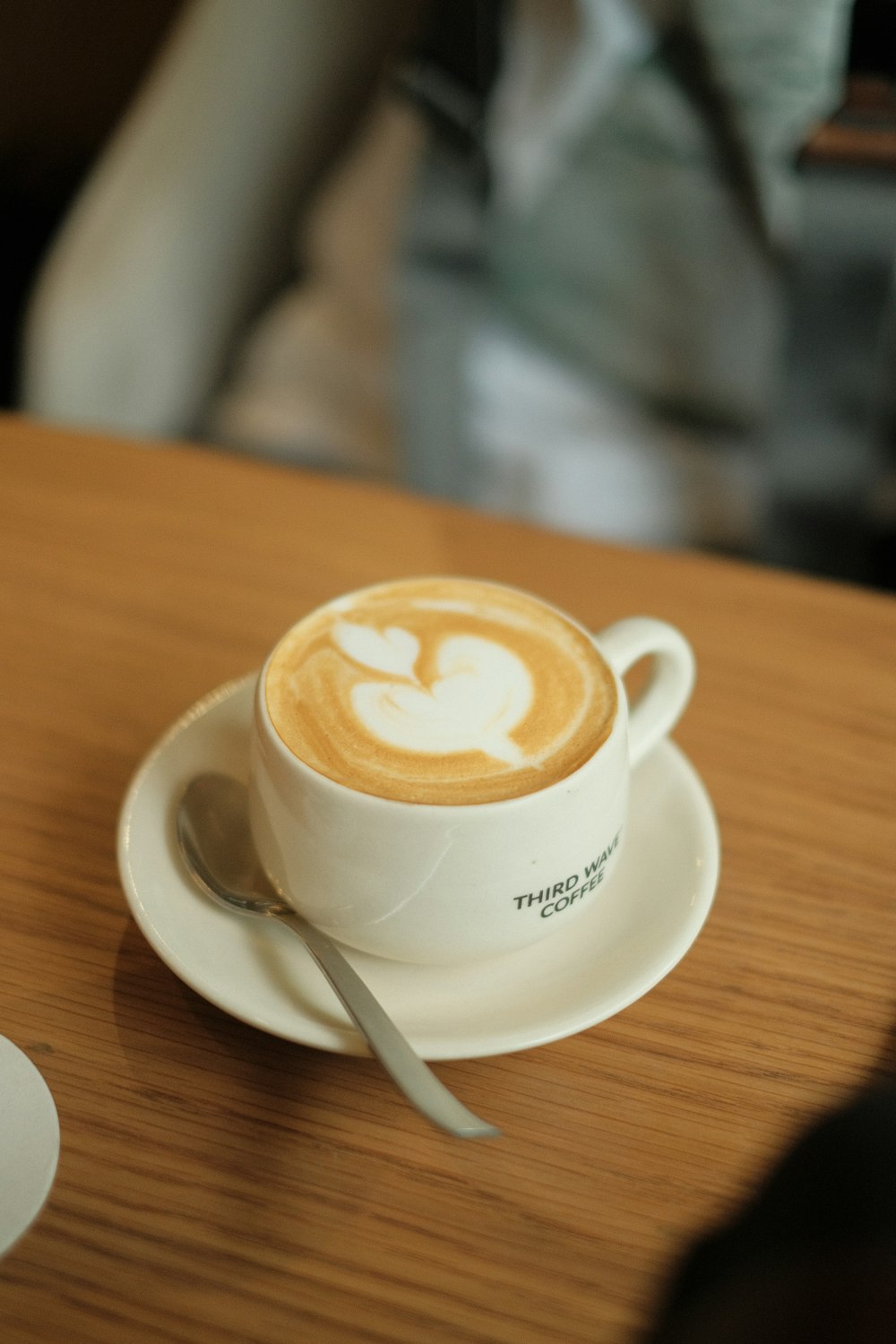 a cappuccino on a saucer with a spoon