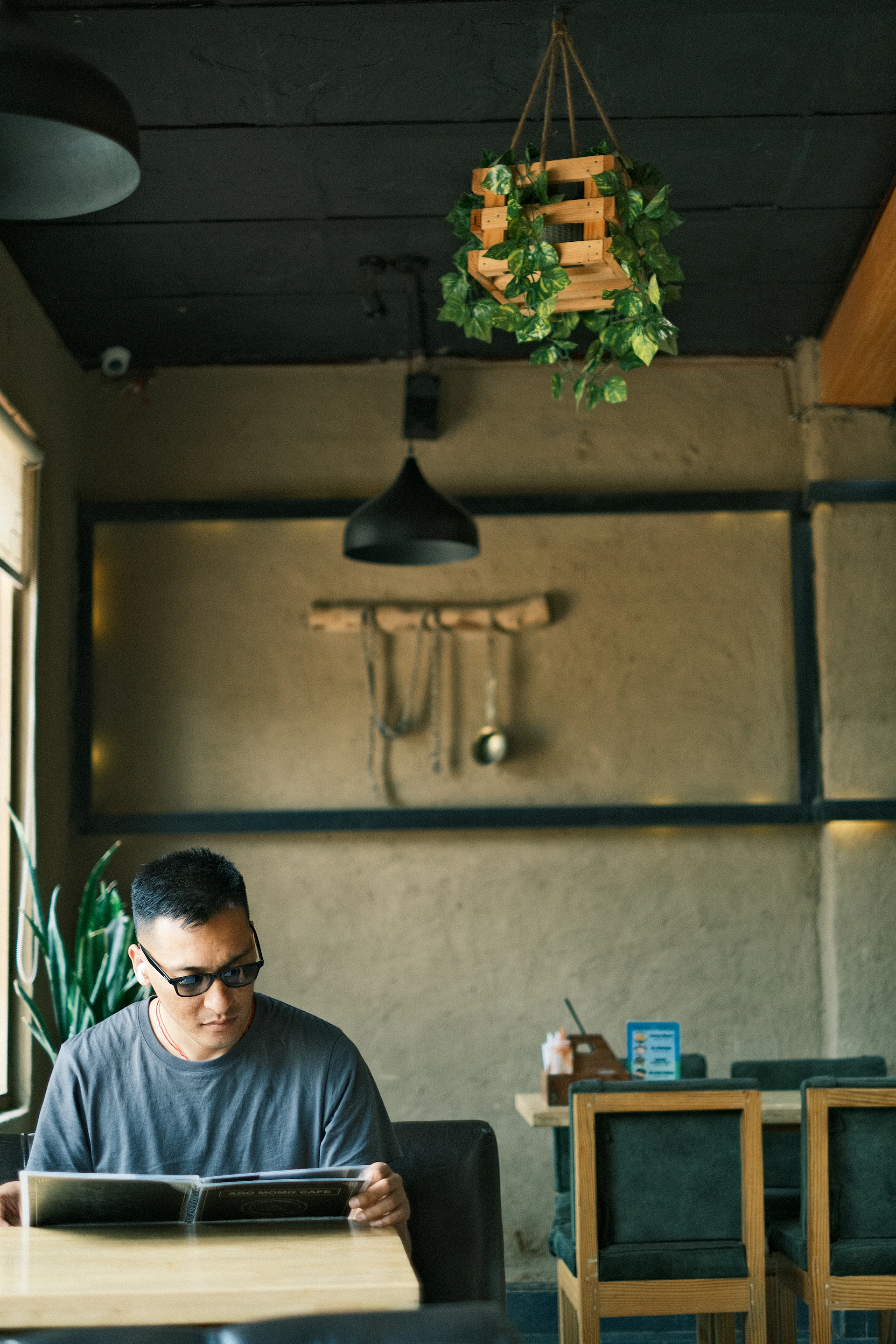 a man sitting at a table with a tablet