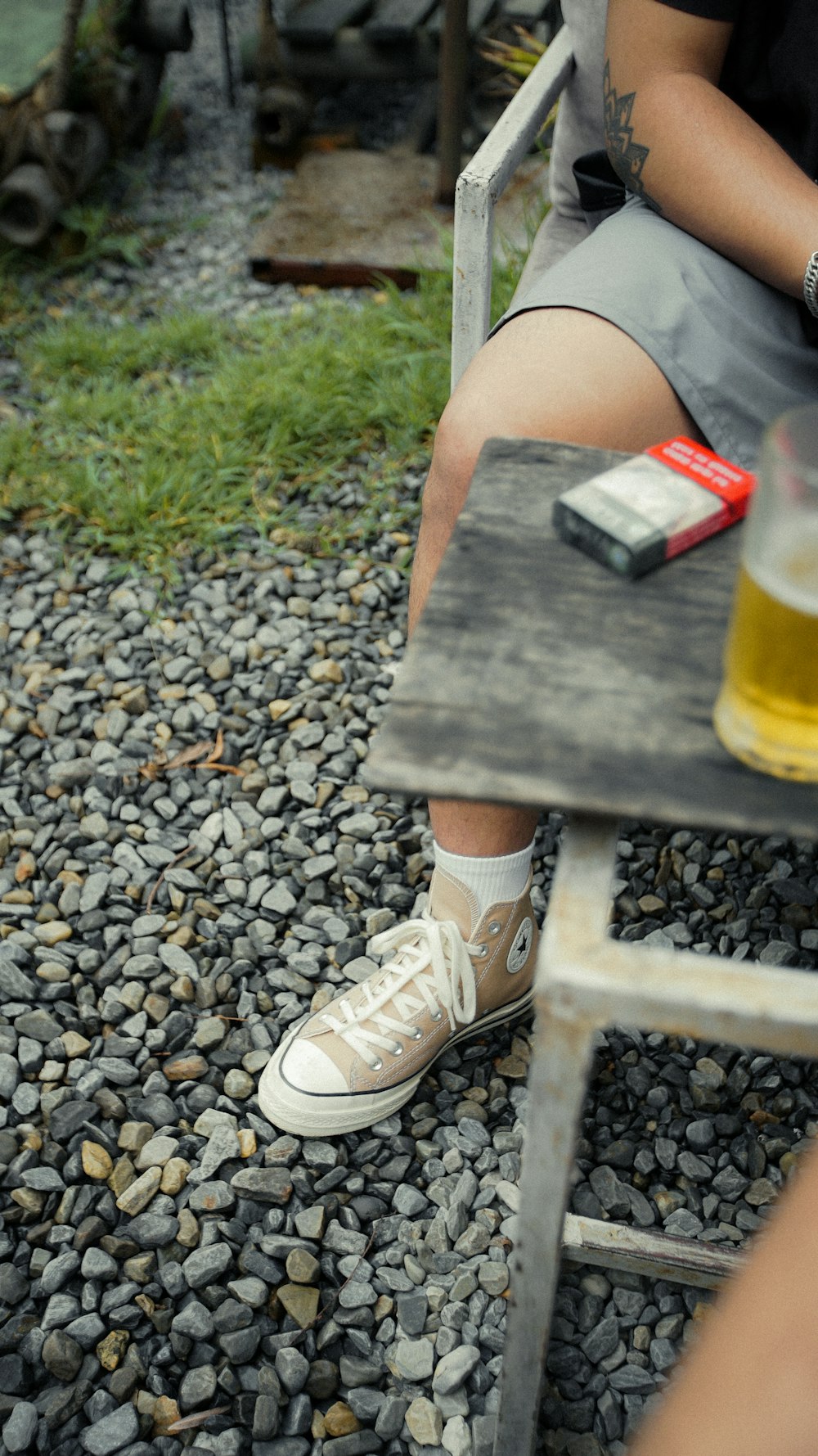 a person sitting on a chair next to a beer