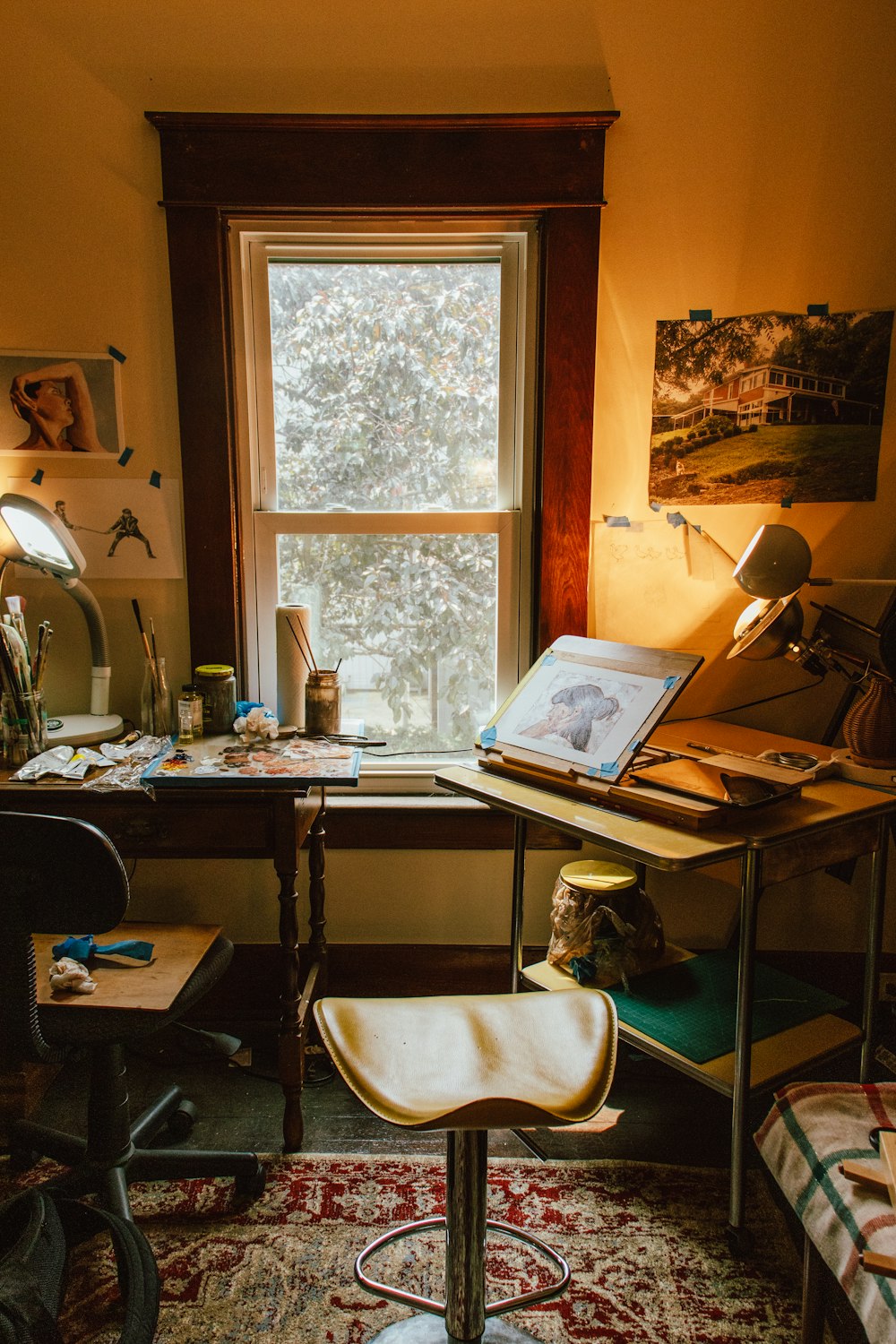 a room with a desk, chair and a window