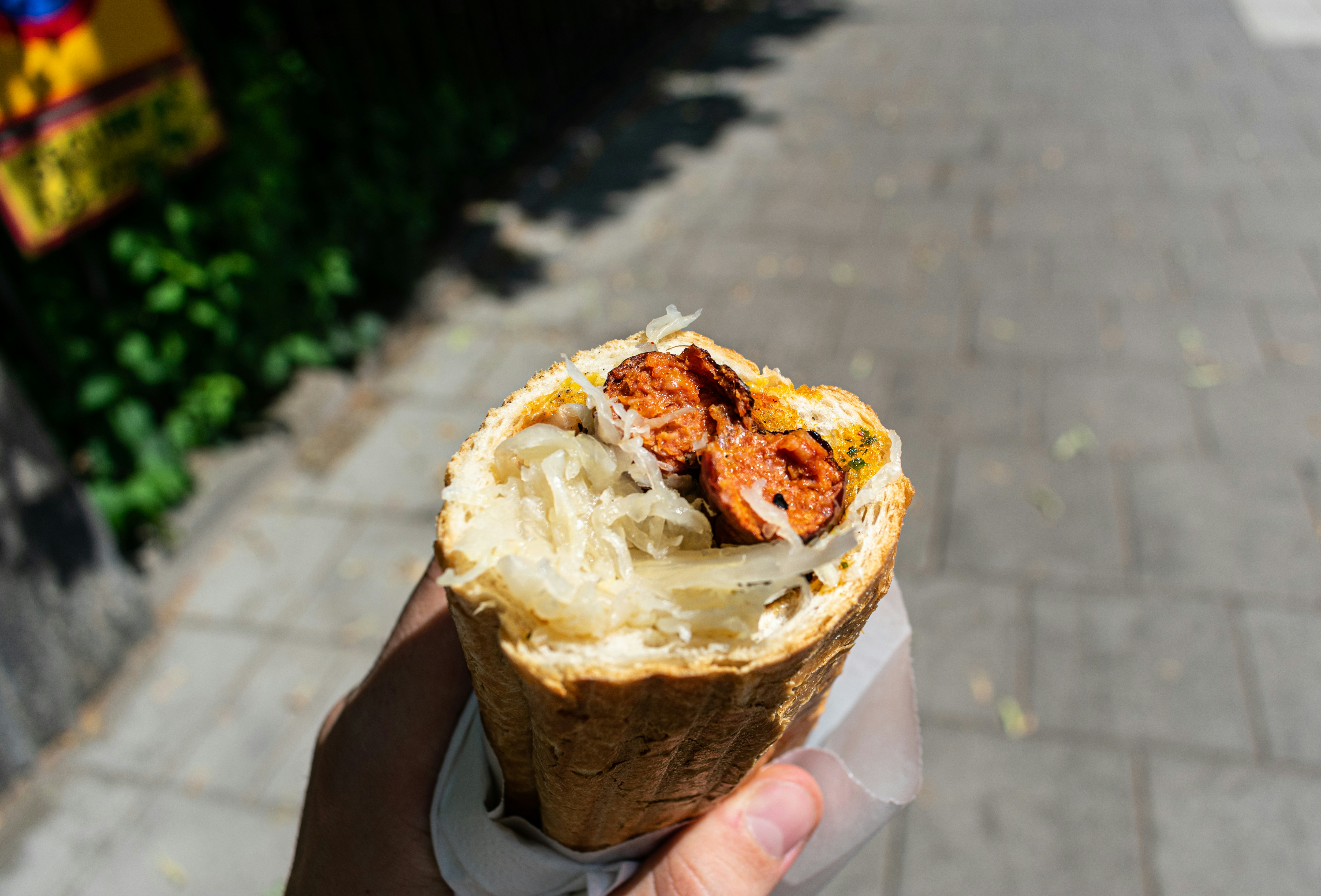 a person holding a sandwich in their hand