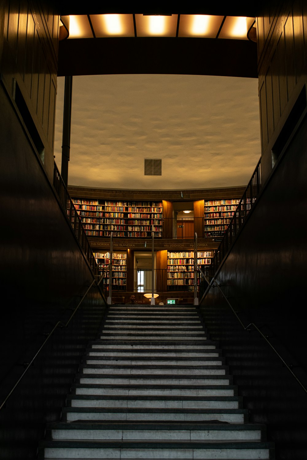 a staircase leading up to a library filled with books