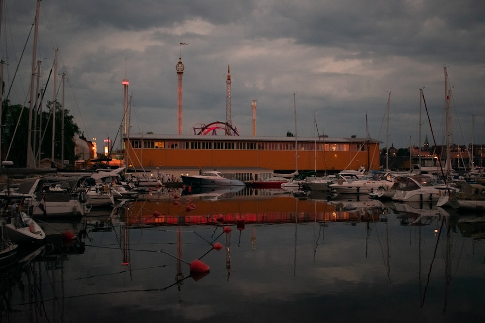 a marina filled with lots of boats under a cloudy sky