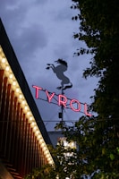 A vibrant outdoor banner displayed at a busy market event in Tirol.