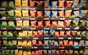 A vibrant display of Lay's chips varieties spread out on a wooden table