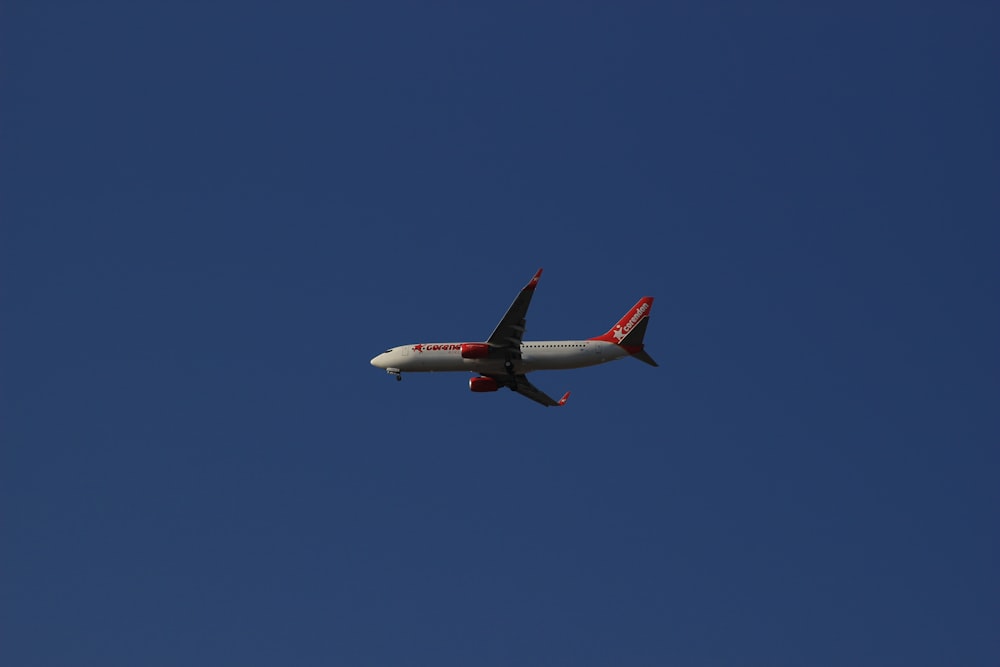 an airplane is flying in a clear blue sky