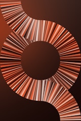 A visually striking design featuring a series of concentric circles and swirling patterns composed of multicolored lines. The lines create a dynamic, flowing effect that draws the eye across the image.