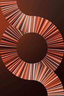 A visually striking design featuring a series of concentric circles and swirling patterns composed of multicolored lines. The lines create a dynamic, flowing effect that draws the eye across the image.